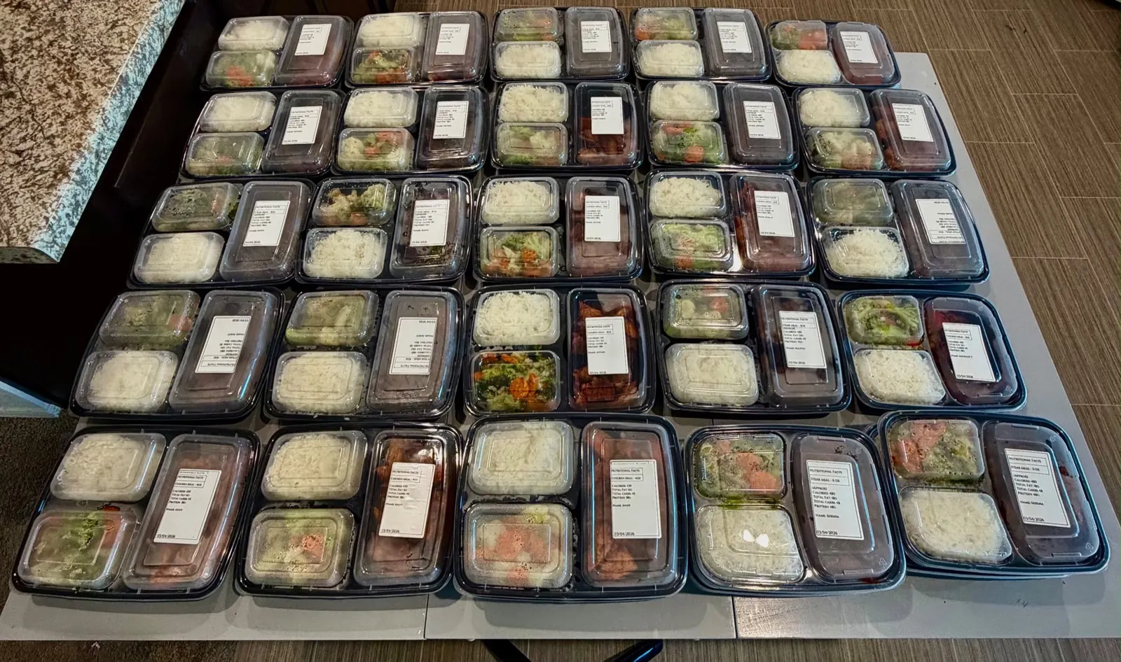 A large spread of freshly packed Tastee Meals meal prep containers